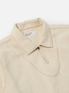 The Ecru Koko Cotlin Smock Overshirt is shown from the back as a flat lay against a plain white background. The image highlights the clean, simple construction of the rear panel, the straight hem, and the textured appearance of the ecru cotton-linen fabric.