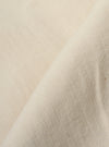 A close-up fabric swatch of the Ecru Koko Cotlin Smock Overshirt highlights the light ecru color and the textured, slubby weave of the cotton-linen blend fabric.