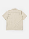 The Ecru Koko Cotlin S/S Fatigue Shirt is shown from the back as a flat lay against a plain white background. The image highlights the clean, simple construction of the shirt's rear panel and the short sleeves. The fabric is a light ecru cotton-linen blend with a visible textured weave.