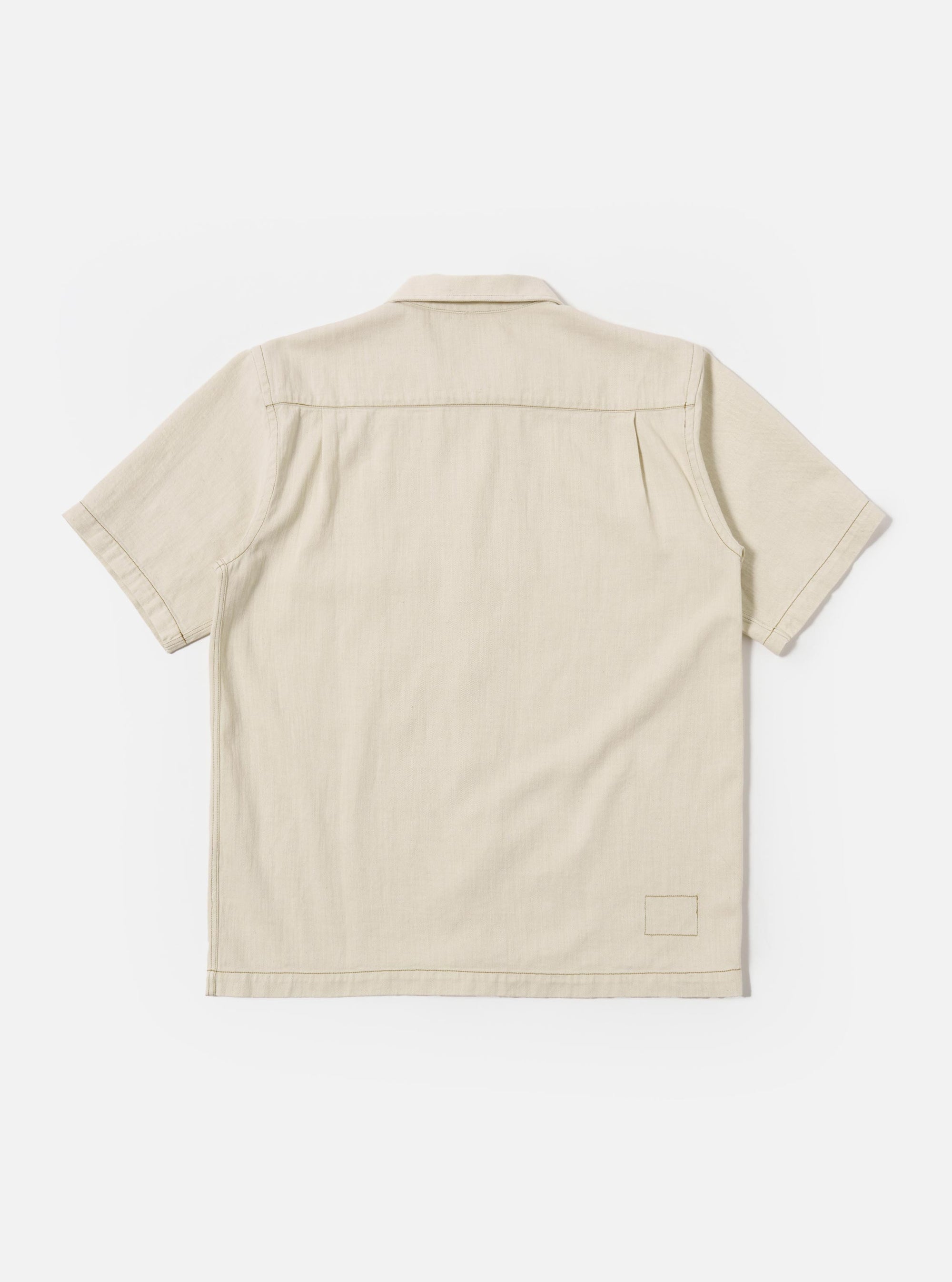 The Ecru Koko Cotlin S/S Fatigue Shirt is shown from the back as a flat lay against a plain white background. The image highlights the clean, simple construction of the shirt's rear panel and the short sleeves. The fabric is a light ecru cotton-linen blend with a visible textured weave.