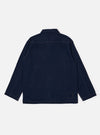 The Indigo Recycled Herringbone Smock Overshirt is shown from the back as a flat lay against a plain white background. The image highlights the garment's clean back panel and straight hem. The deep indigo blue fabric features a subtle herringbone weave texture.