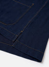 The Indigo Recycled Herringbone Smock Overshirt is shown from the back as a flat lay against a plain white background. The image highlights the straight hem, which is slightly longer than the front, and the textured herringbone weave of the indigo-colored fabric.
