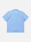 The Sky Blue Seersucker Shirting Road Shirt is shown from the back as a flat lay against a plain white background. The image highlights the shirt's short sleeves, straight hem, and the puckered texture of the sky blue seersucker fabric.
