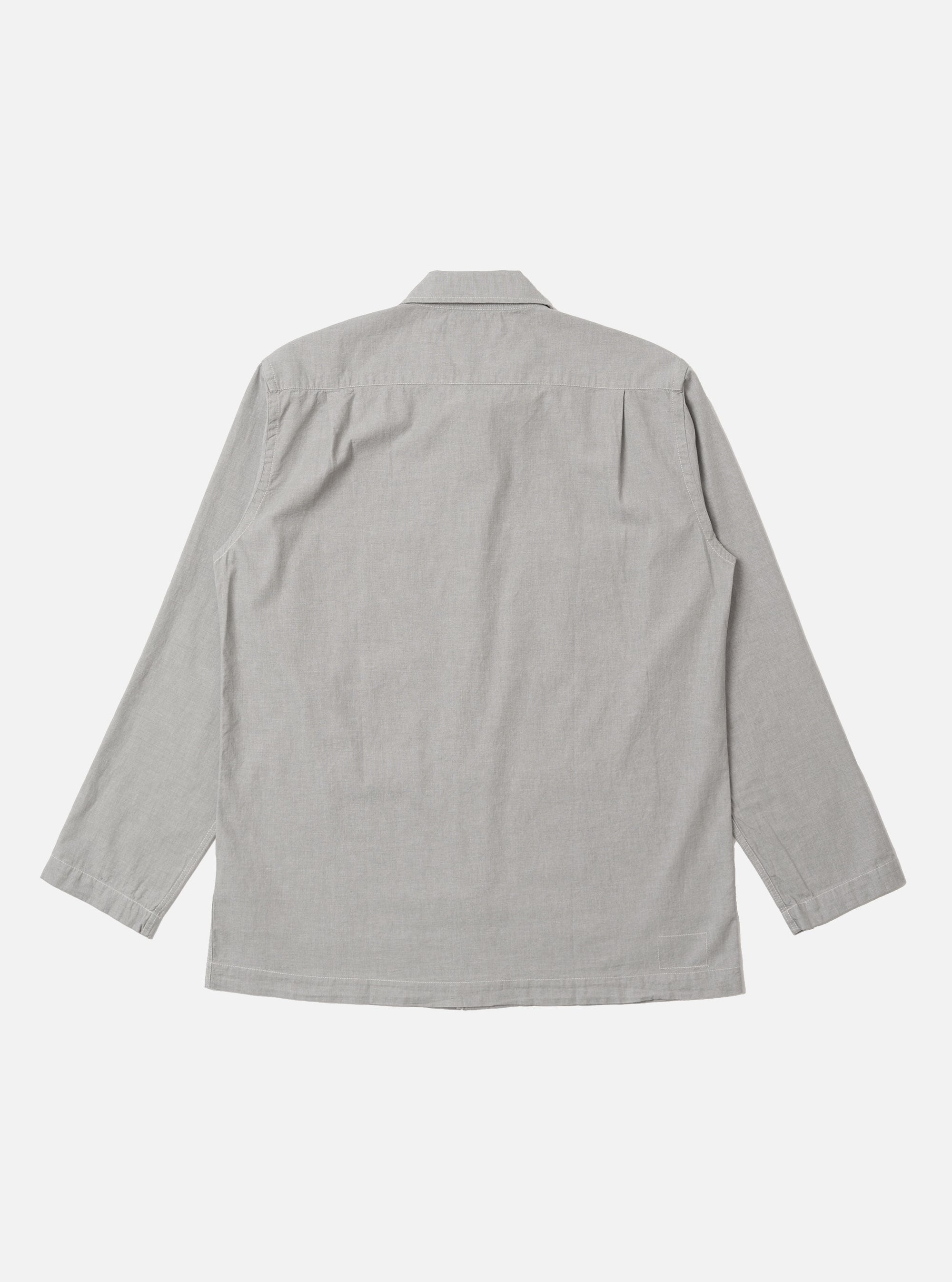 The Grey Izumi Cotton Dockside is shown from the back as a flat lay against a plain white background. The overshirt features a simple, straight-cut back panel with a horizontal yoke across the shoulders and a straight hem. The grey cotton fabric has a fine, smooth texture.