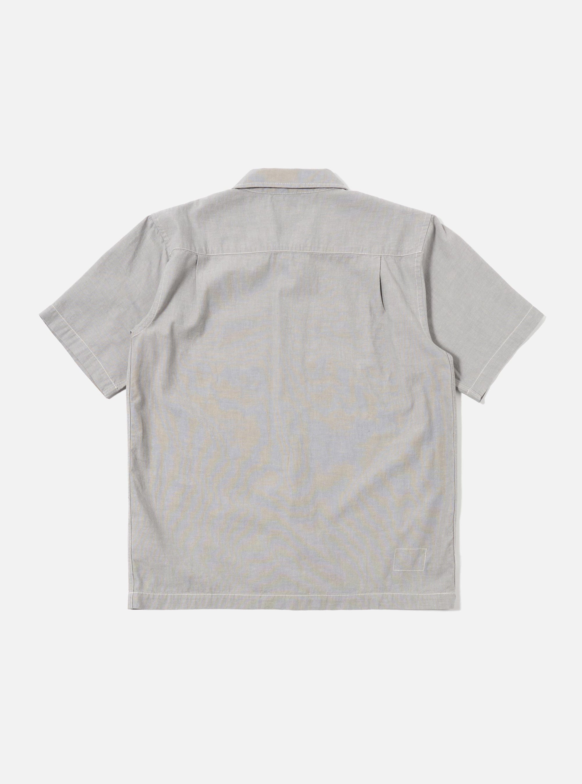 The Grey Izumi Cotton S/S Fatigue Shirt is shown from the back as a flat lay against a plain white background. The image highlights the shirt's straight hem, short sleeves, and the textured, slubby character of the grey cotton-linen fabric.