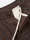 The Brown Chester Stripe Oxford Pant is displayed from the back as a flat lay against a plain white background. The image highlights the elasticated waistband with a drawstring and two rear pockets, featuring one buttoned flap and one button jetted closure. The brown cotton fabric shows a subtle pinstripe pattern and a textured seersucker weave.