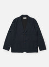 The Navy Valencia Cotton Two Button Jacket is displayed as a flat lay against a plain white background. The jacket features notched lapels, a two-button front closure, and two large patch pockets at the waist. The dark navy fabric has a smooth, structured appearance.