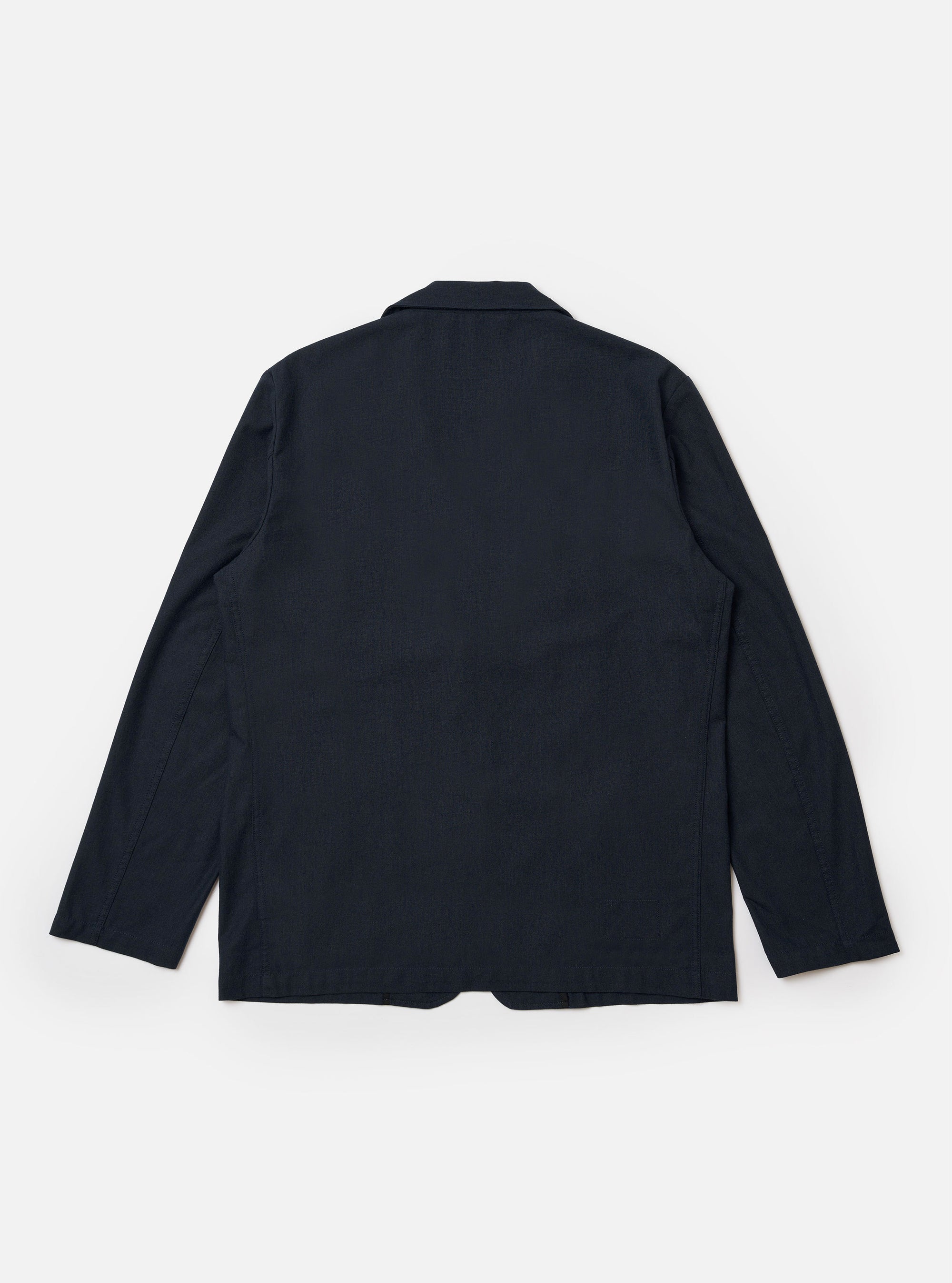 The Navy Valencia Cotton Two Button Jacket is shown from the back as a flat lay against a plain white background. The image highlights the jacket's clean construction, featuring a central vertical seam and a single vent at the hem. The navy blue cotton fabric has a smooth, matte finish.