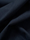 The Navy Valencia Cotton Two Button Jacket is shown in a detail view as a flat lay against a plain white background. The image highlights the smooth, technical texture of the navy blue Valencia cotton fabric and the construction of the front buttons and lapel.