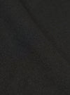 A close-up swatch image of the Black Valencia Cotton Pleated Track Pant fabric highlights the fine, plain weave and smooth texture of the black material. The fabric fills the entire frame, providing a detailed view of the lightweight suiting blend.