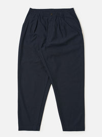 The Navy Valencia Cotton Pleated Track Pant is shown as a flat lay against a plain white background. The trousers feature an elasticated waistband with an external drawstring, a single pleat at the front, and two side pockets. The fabric is a dark navy blue with a smooth, clean finish.