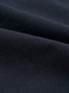 A close-up swatch image of the Navy Valencia Cotton Pleated Track Pant fabric. The image focuses on the textile detail, showing a deep navy blue color with a fine, clean, plain weave texture.