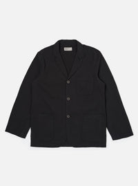 The Black Merida Seersucker Three Button Jacket is shown as a flat lay against a white background. This loose-fitting, unstructured jacket features three front buttons, a single chest patch pocket, and two lower patch pockets. The black cotton fabric has a distinct puckered seersucker texture.