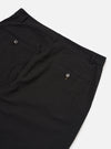 The Black Merida Seersucker Military Chino is shown from a rear angle as a flat lay against a plain white background. The image highlights the two buttoned flap back pockets and the "Hollywood" one-piece waistband. The black cotton fabric features a distinct puckered seersucker texture throughout.
