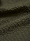 A close-up swatch image of the Olive Merida Seersucker Military Chino fabric highlights the olive green color and the characteristic puckered texture of the cotton seersucker material.