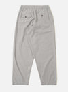 The Grey Izumi Cotton Oxford Pant is shown from the back as a flat lay against a plain white background. The image highlights the two rear pockets, including one with a buttoned flap and one buttoned jetted pocket, as well as the elasticated drawstring waistband. The grey cotton fabric features a subtle textured weave.