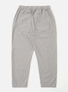 The Grey Izumi Cotton Hi Water Trouser is shown from the back as a flat lay against a plain white background. The image highlights the two rear button-down flap pockets and the elasticated waistband with a visible drawstring. The grey cotton fabric features a subtle, textured weave.