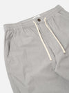 The Grey Izumi Cotton Hi Water Trouser is shown from the back as a flat lay against a plain white background. The trousers feature a drawcord-adjustable waistband and two large rear patch pockets. The garment is made from a grey cotton fabric and has a slightly cropped leg length.