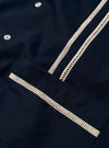 The Navy Classic Oxford Tropicana Shirt is shown from the back as a flat lay against a white background. The image highlights the one-piece collar, a straight back yoke, and a side split hem that is longer at the back. The navy blue Oxford cotton fabric has a visible textured weave.