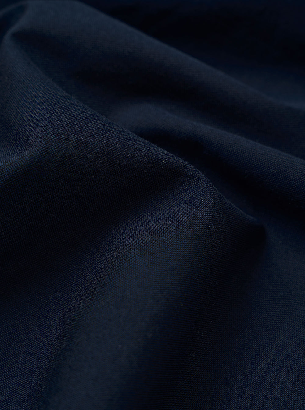 The Navy Classic Oxford Tropicana Shirt is presented as a flat lay against a plain white background. The shirt features a classic button-down front, a pointed collar, and a single patch pocket on the left chest. The deep navy blue fabric shows a visible Oxford weave texture.