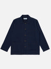 The Indigo Recycled Herringbone Bakers Overshirt is shown as a flat lay against a plain white background. The overshirt features a one-piece collar, a central button-down front, and four front patch pockets: one asymmetric pocket at the chest and three lower pockets including a small coin pocket. The indigo-dyed fabric displays a visible herringbone weave texture throughout.