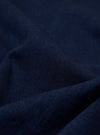 A close-up swatch image of the Indigo Recycled Herringbone Bakers Overshirt fabric. The image focuses on the textile detail, showing a deep indigo blue color with a distinct herringbone weave pattern.