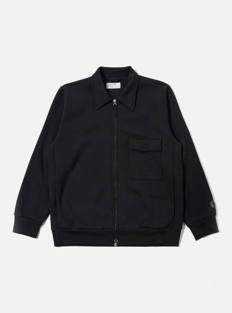 The Black Recycled Cotton Blend Jersey Tyler Jacket is shown as a flat lay against a plain white background. The jacket features a full-zip front, a classic pointed collar, and two large patch pockets at the waist. The sleeve cuffs and hem are finished with a simple, clean stitch, and the black jersey fabric has a smooth, soft texture.