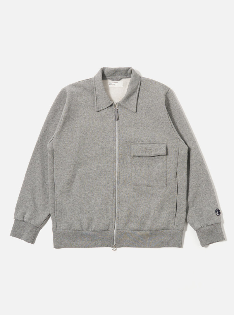 The Grey Marl Recycled Cotton Blend Jersey Tyler Jacket is shown as a flat lay against a white background. The jacket features a self-fabric collar, a two-way central zip closure, and a single chest patch pocket with a velcro fastening. It has ribbed cuffs and a ribbed hem, along with two side seam pockets. The fabric is a textured grey marl jersey.