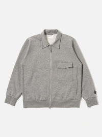 The Grey Marl Recycled Cotton Blend Jersey Tyler Jacket is shown as a flat lay against a white background. The jacket features a self-fabric collar, a two-way central zip closure, and a single chest patch pocket with a velcro fastening. It has ribbed cuffs and a ribbed hem, along with two side seam pockets. The fabric is a textured grey marl jersey.