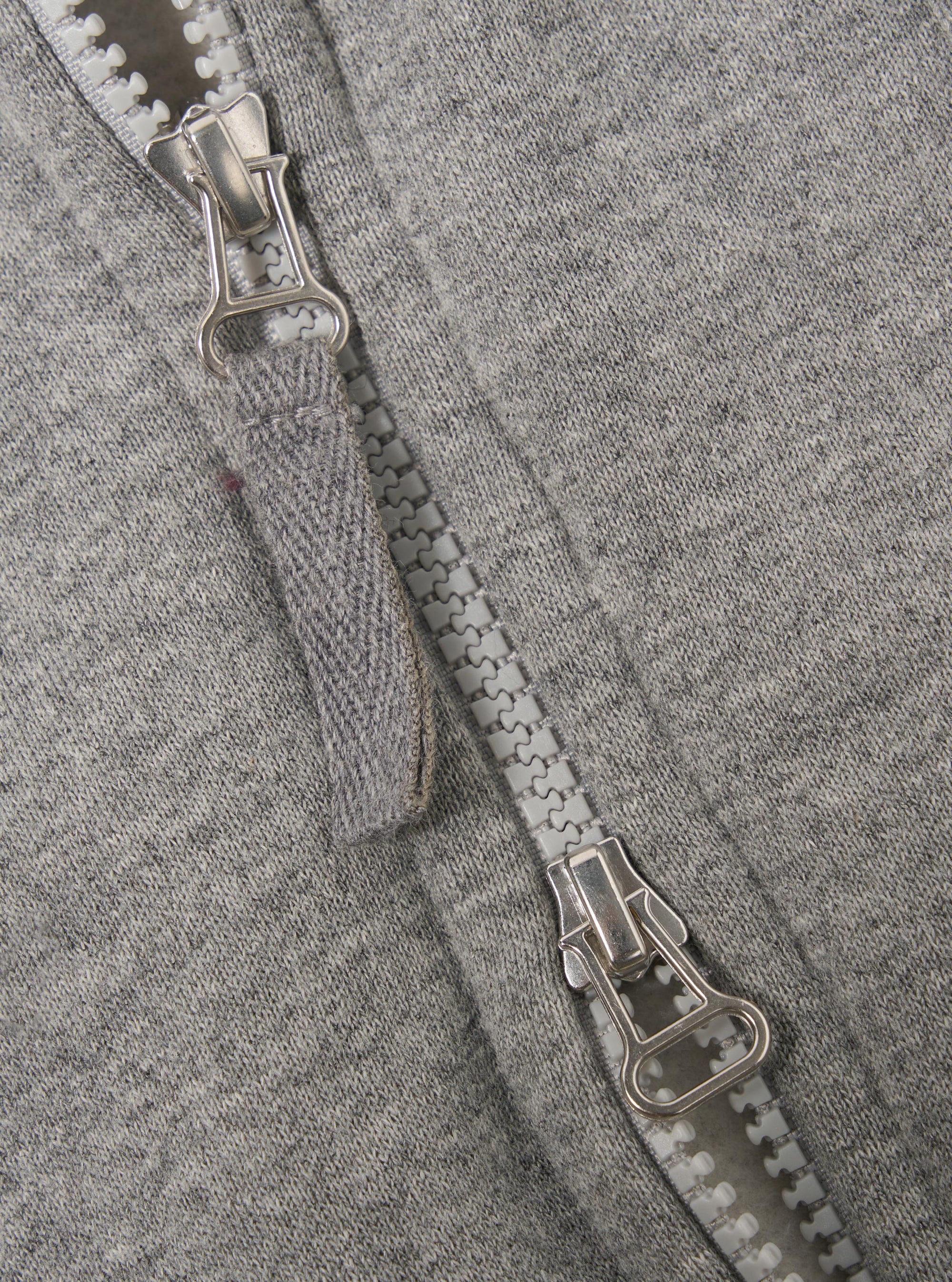 The Grey Marl Recycled Cotton Blend Jersey Tyler Jacket is shown from the back as a flat lay against a plain white background. The image highlights the jacket's simple rear construction, the soft grey marl texture of the recycled cotton blend fabric, and the ribbed hem and cuffs.
