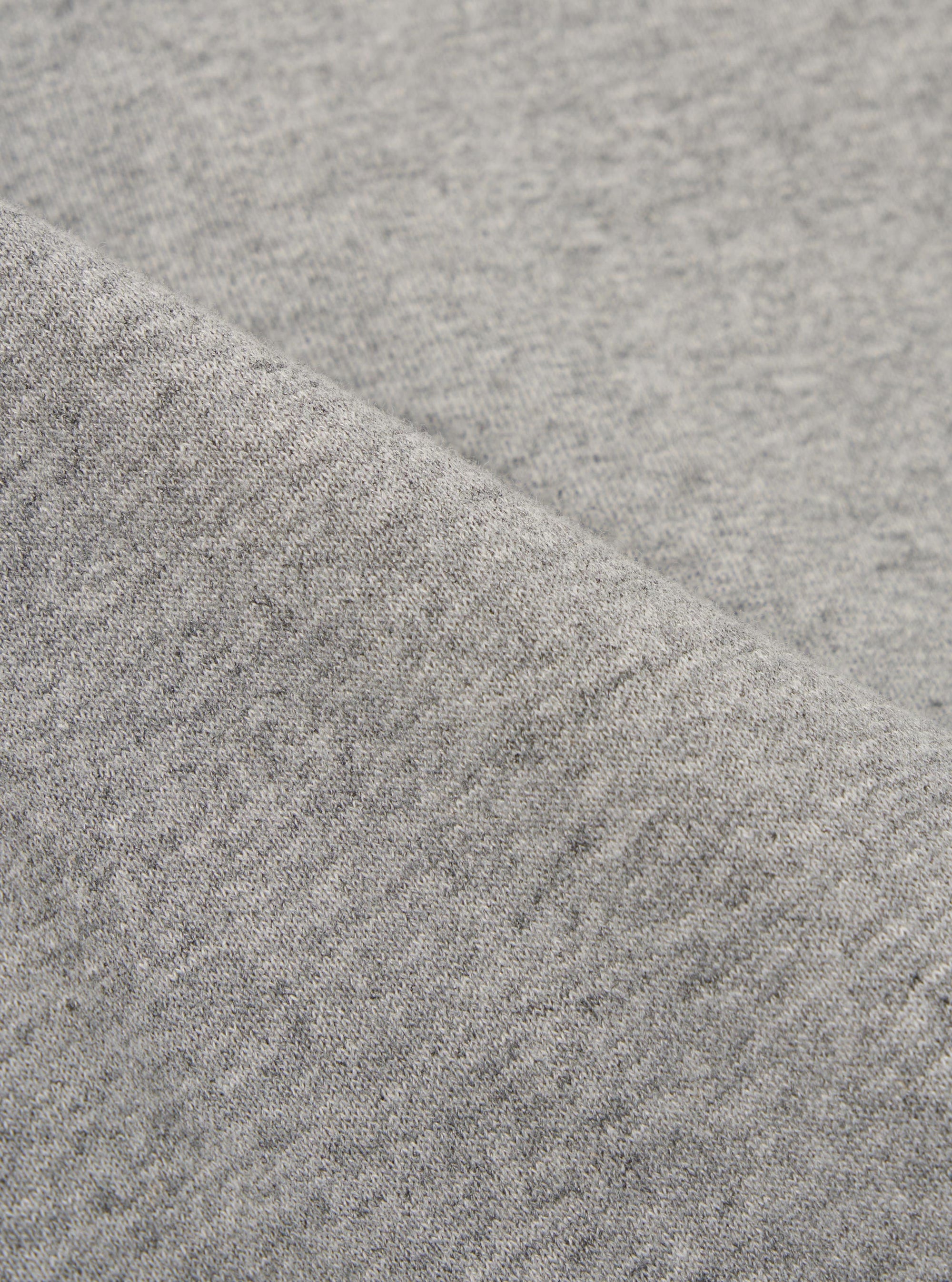 A close-up fabric swatch of the Grey Marl Recycled Cotton Blend Jersey Tyler Jacket highlights the mottled grey color and soft, knitted texture of the recycled cotton blend material. The image provides a detailed view of the fabric's weave and finish.