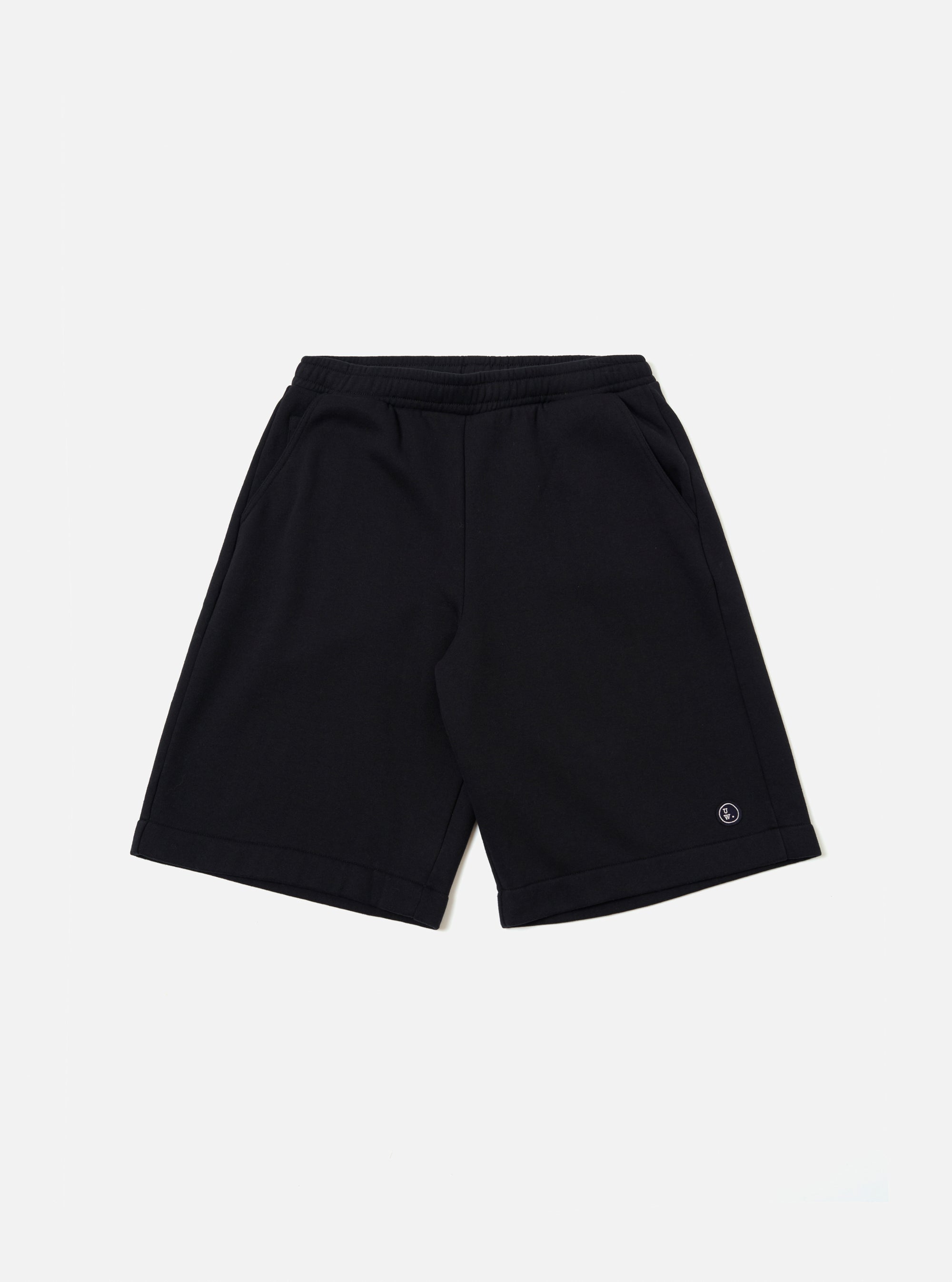 The Black Recycled Cotton Blend Jersey Vacation Short is shown as a flat lay against a plain white background. The shorts feature an elasticated waistband with a matching drawstring and two large patch pockets on the front. The black jersey fabric has a soft, matte finish.