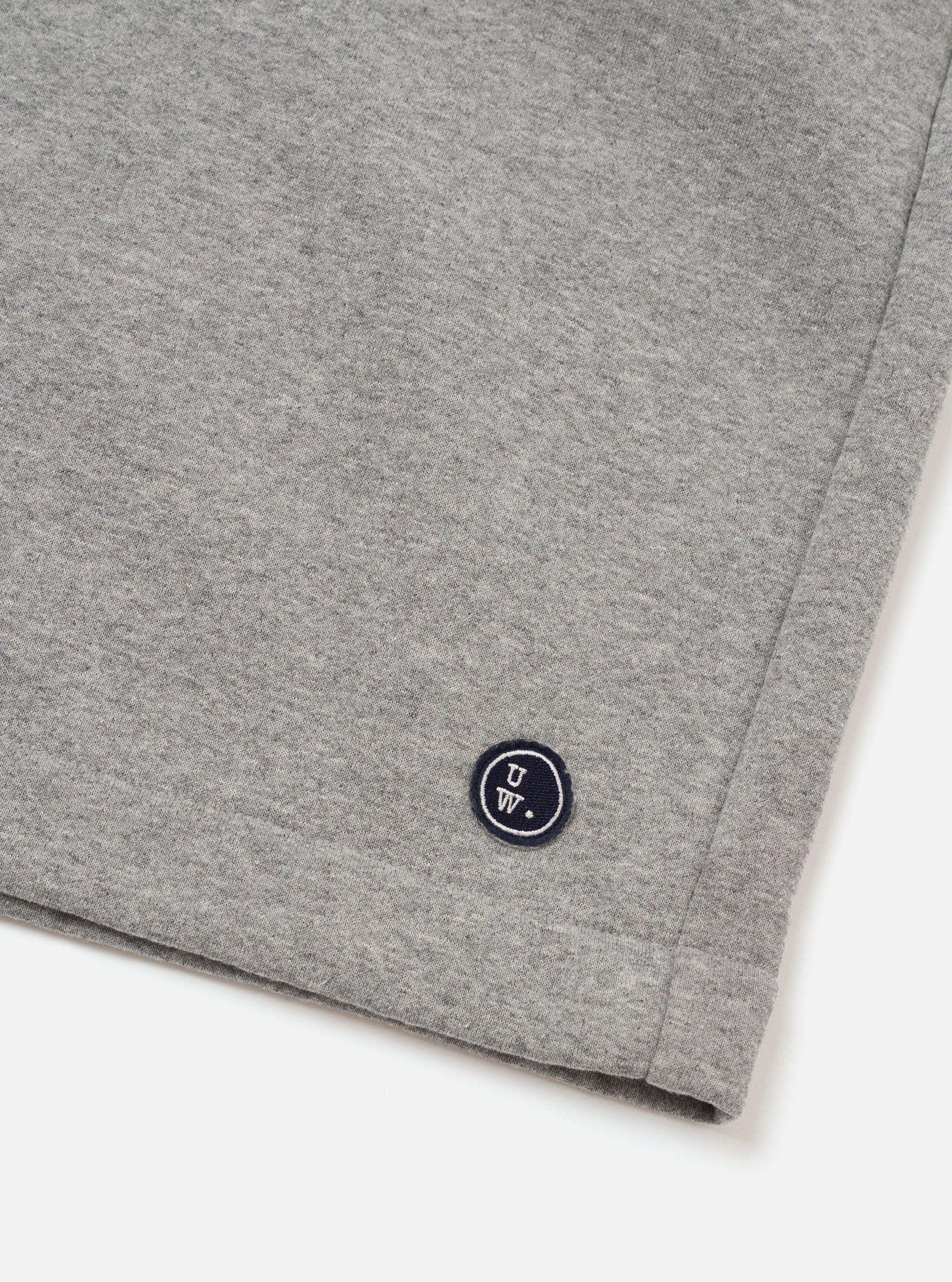 The Grey Marl Recycled Cotton Blend Jersey Vacation Short is shown from the back as a flat lay against a plain white background. The shorts feature an elasticated waistband and a single patch pocket on the right rear side. The fabric has a soft, heathered grey marl jersey texture.