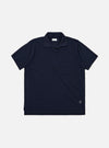 The Bright Navy Piquet Vacation Polo is shown as a flat lay against a white background. The polo features a buttonless open collar, a single patch pocket on the left chest, and a straight hem. The bright navy cotton fabric has a visible textured piquet weave.