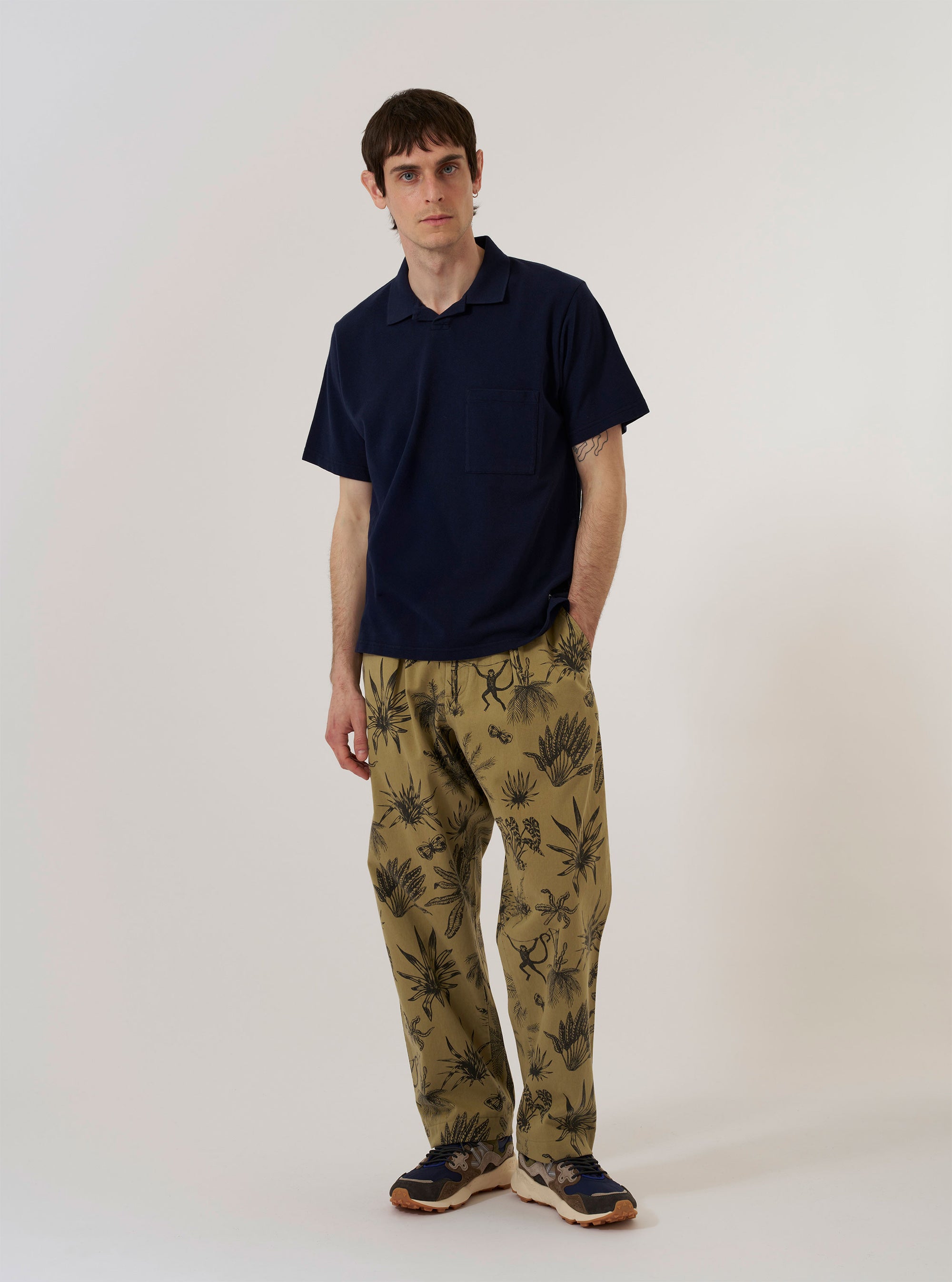 The Bright Navy Piquet Vacation Polo is shown as a flat lay against a white background. The polo features a textured piqué fabric, a relaxed open one-piece collar, and a single patch pocket on the chest.