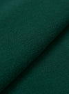 A close-up fabric swatch of the Green Piquet Vacation Polo highlights the textured, breathable weave of the green piquet fabric. The image provides a detailed view of the garment's color and knit construction.
