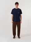 The Bright Navy Organic Jersey Print Pocket Tee is shown as a flat lay against a plain white background. The t-shirt features a crew neckline, short sleeves, and a single patch pocket on the left chest. A small, circular graphic print is visible on the pocket. The garment is made from a smooth, bright navy organic cotton jersey.