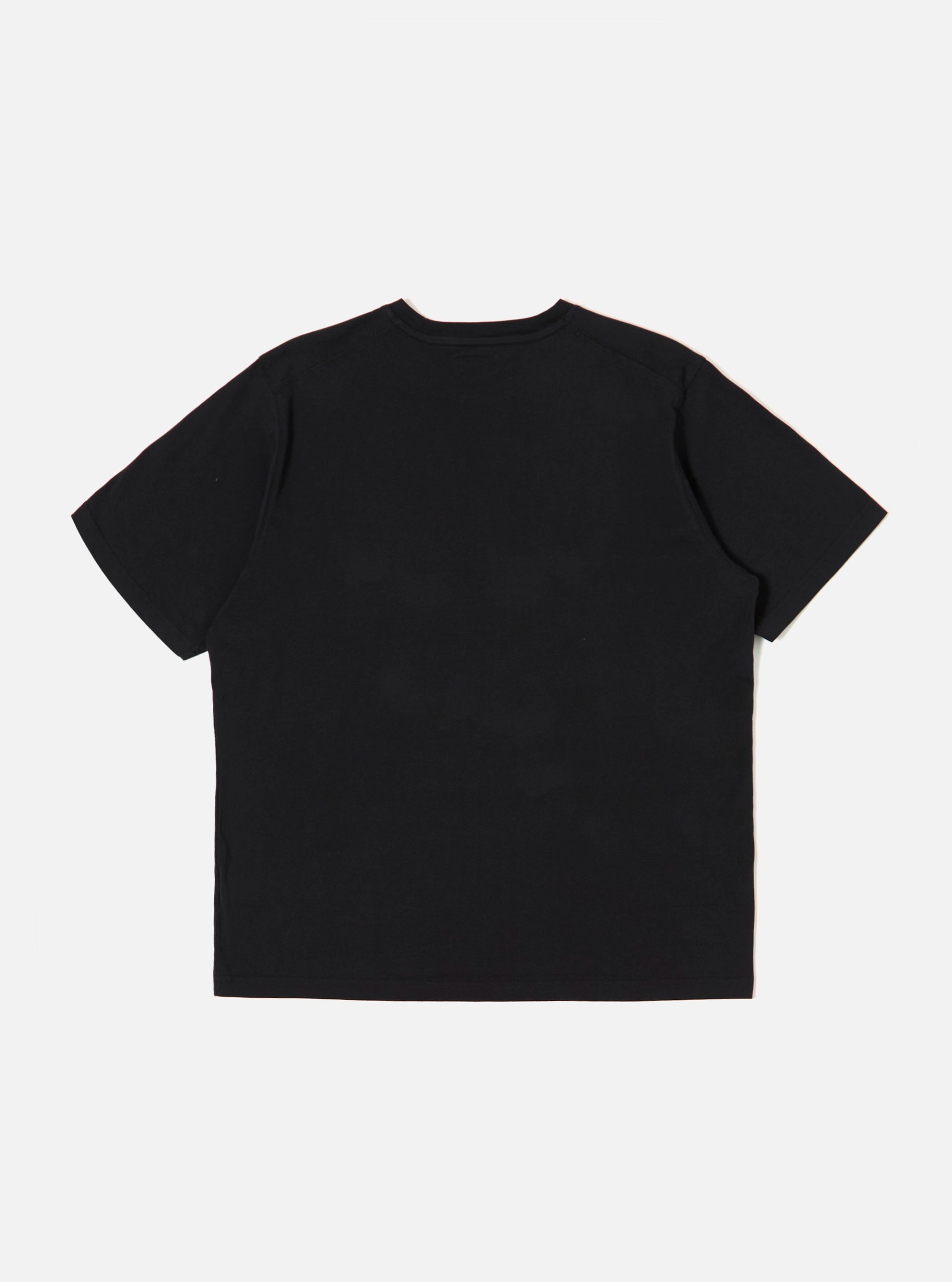 The Black Organic Jersey Print Pocket Tee is shown from the back as a flat lay against a plain white background. The image highlights the clean construction of the garment's rear panel, featuring a ribbed crew neckline and short sleeves. The fabric is a solid black organic cotton jersey with visible stitching at the hem and cuffs.
