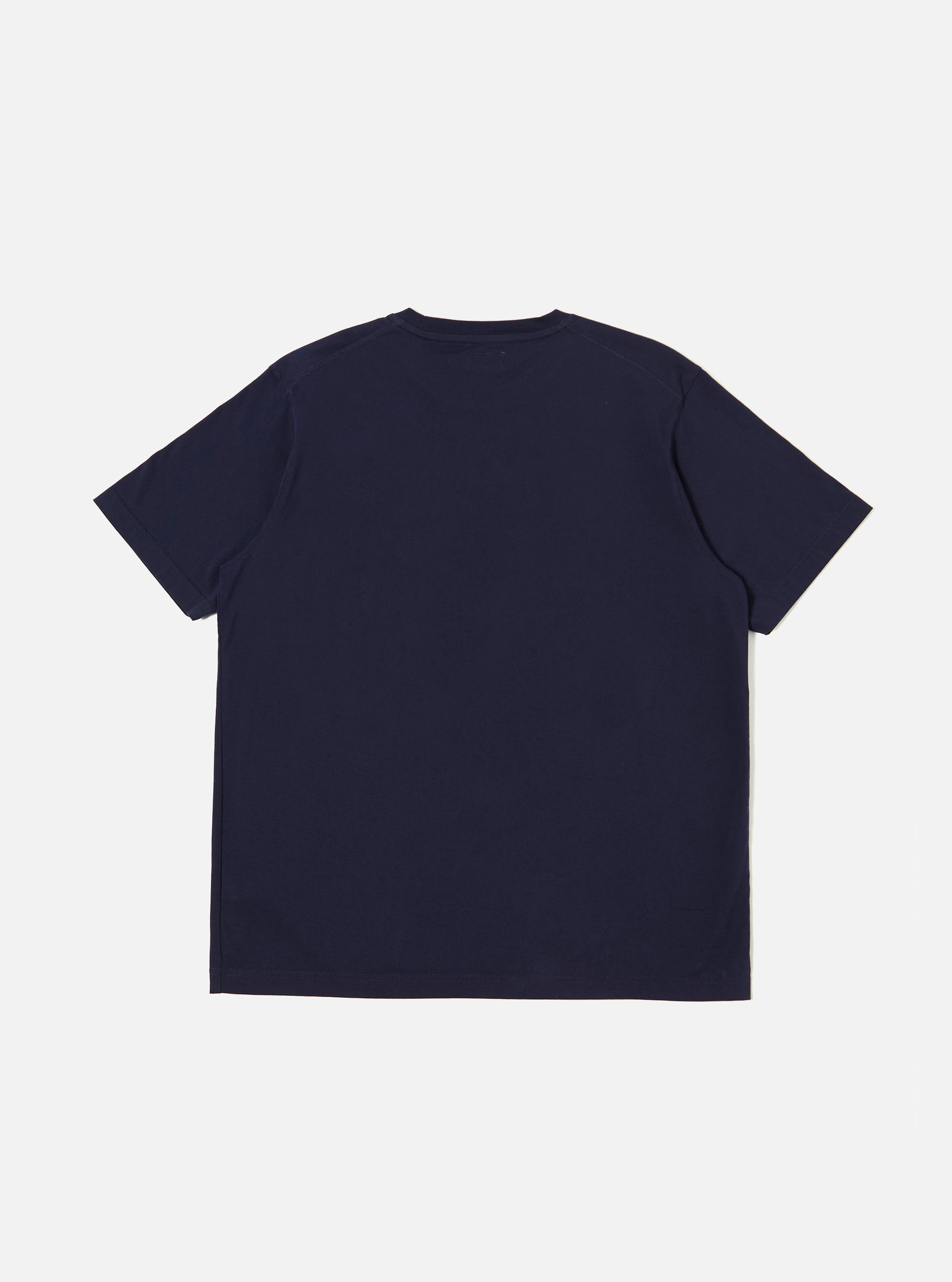 The Bright Navy Organic Jersey Print Pocket Tee is shown from the back as a flat lay against a plain white background. The image highlights the clean, simple construction of the garment's rear panel and the smooth texture of the bright navy organic cotton fabric.