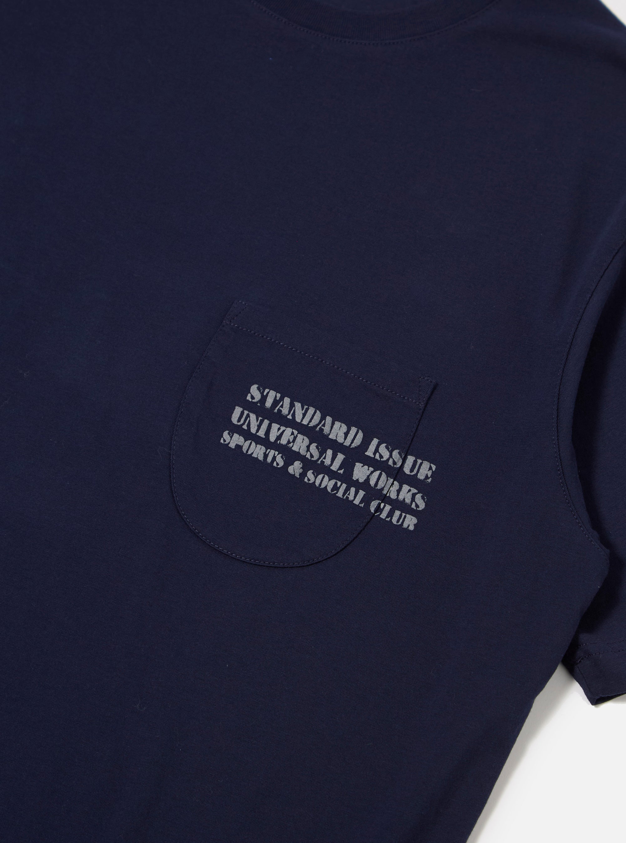 The Bright Navy Organic Jersey Print Pocket Tee is shown from the back as a flat lay against a plain white background. The short-sleeved t-shirt features a ribbed crew neckline and a straight hem. The garment is made from a solid bright navy organic cotton jersey fabric.