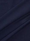 A close-up swatch image of the Bright Navy Organic Jersey Print Pocket Tee fabric highlights the vibrant navy blue color and the soft, fine-knit texture of the organic cotton jersey. The material fills the entire frame, providing a detailed view of the garment's color and construction.