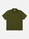 The Olive Rugby Jersey Oversized Vacation Polo is shown as a flat lay against a white background. The garment features an oversized fit, a one-piece collar, a short buttonless placket, and a single patch pocket on the left chest. The short sleeves and stepped hem with small side vents are prominent.