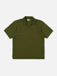 The Olive Rugby Jersey Oversized Vacation Polo is shown as a flat lay against a white background. The garment features an oversized fit, a one-piece collar, a short buttonless placket, and a single patch pocket on the left chest. The short sleeves and stepped hem with small side vents are prominent.