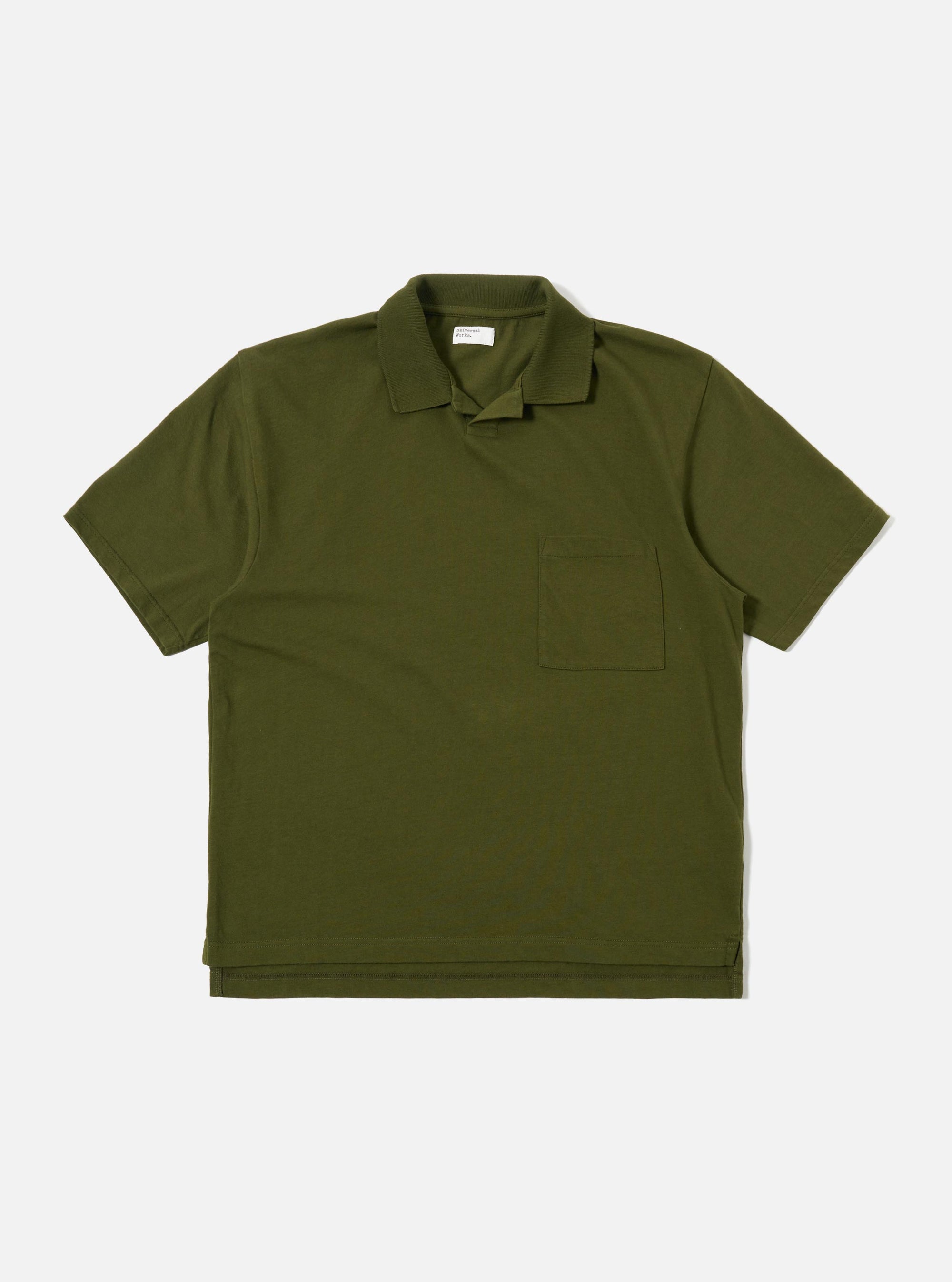 The Olive Rugby Jersey Oversized Vacation Polo is shown as a flat lay against a white background. The garment features an oversized fit, a one-piece collar, a short buttonless placket, and a single patch pocket on the left chest. The short sleeves and stepped hem with small side vents are prominent.