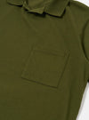 The Olive Rugby Jersey Oversized Vacation Polo is shown as a flat lay against a white background. The image displays the back of the garment, highlighting the oversized fit, the straight hem, and the relaxed drop of the shoulders. The olive green cotton fabric has a visible jersey texture.