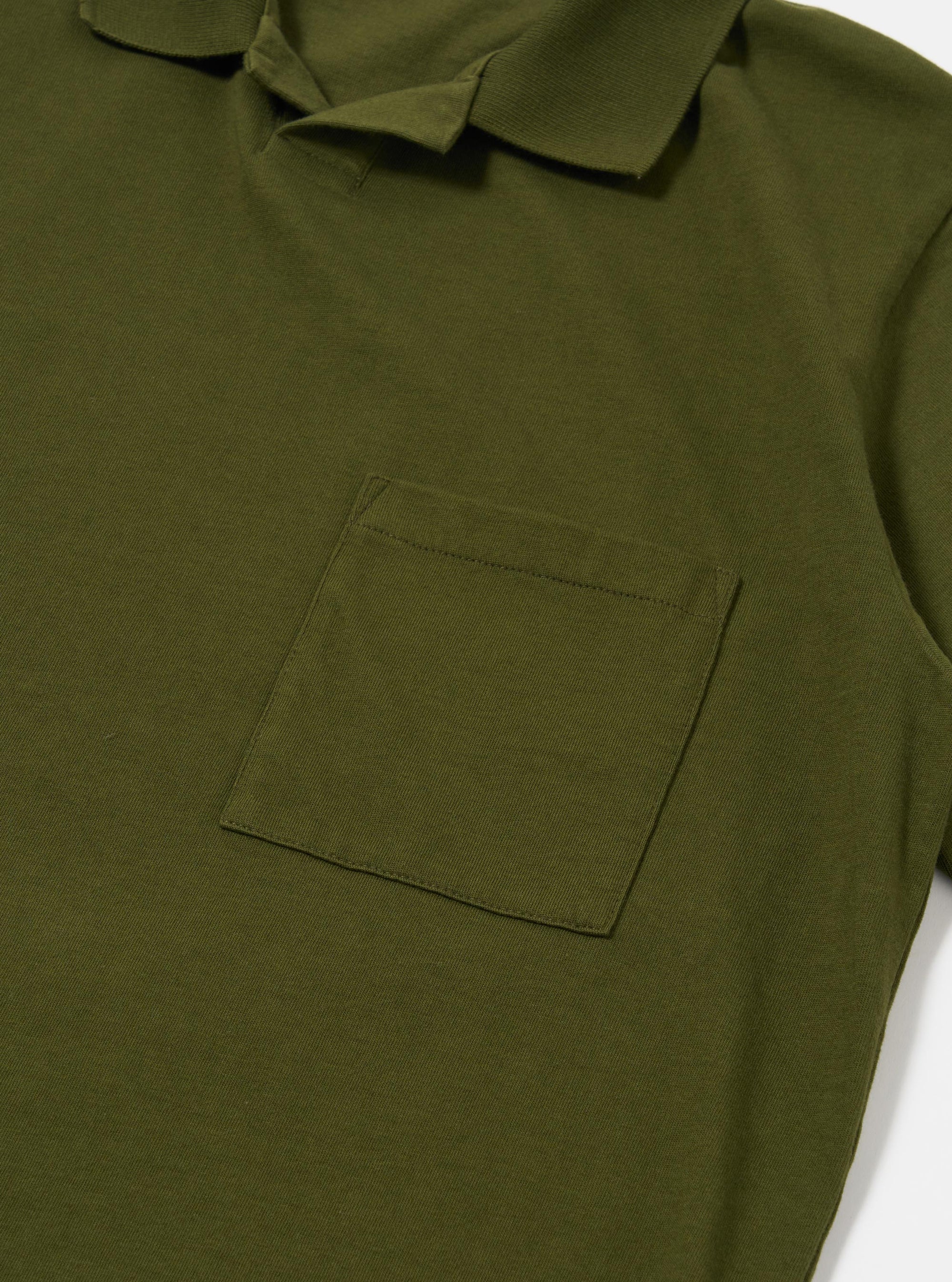 The Olive Rugby Jersey Oversized Vacation Polo is shown as a flat lay against a white background. The image displays the back of the garment, highlighting the oversized fit, the straight hem, and the relaxed drop of the shoulders. The olive green cotton fabric has a visible jersey texture.