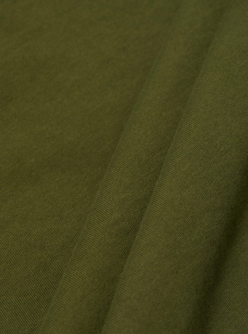 A close-up swatch image of the Olive Rugby Jersey Oversized Vacation Polo fabric. The image focuses on the olive green organic cotton material, highlighting its soft, jersey knit texture and consistent color.