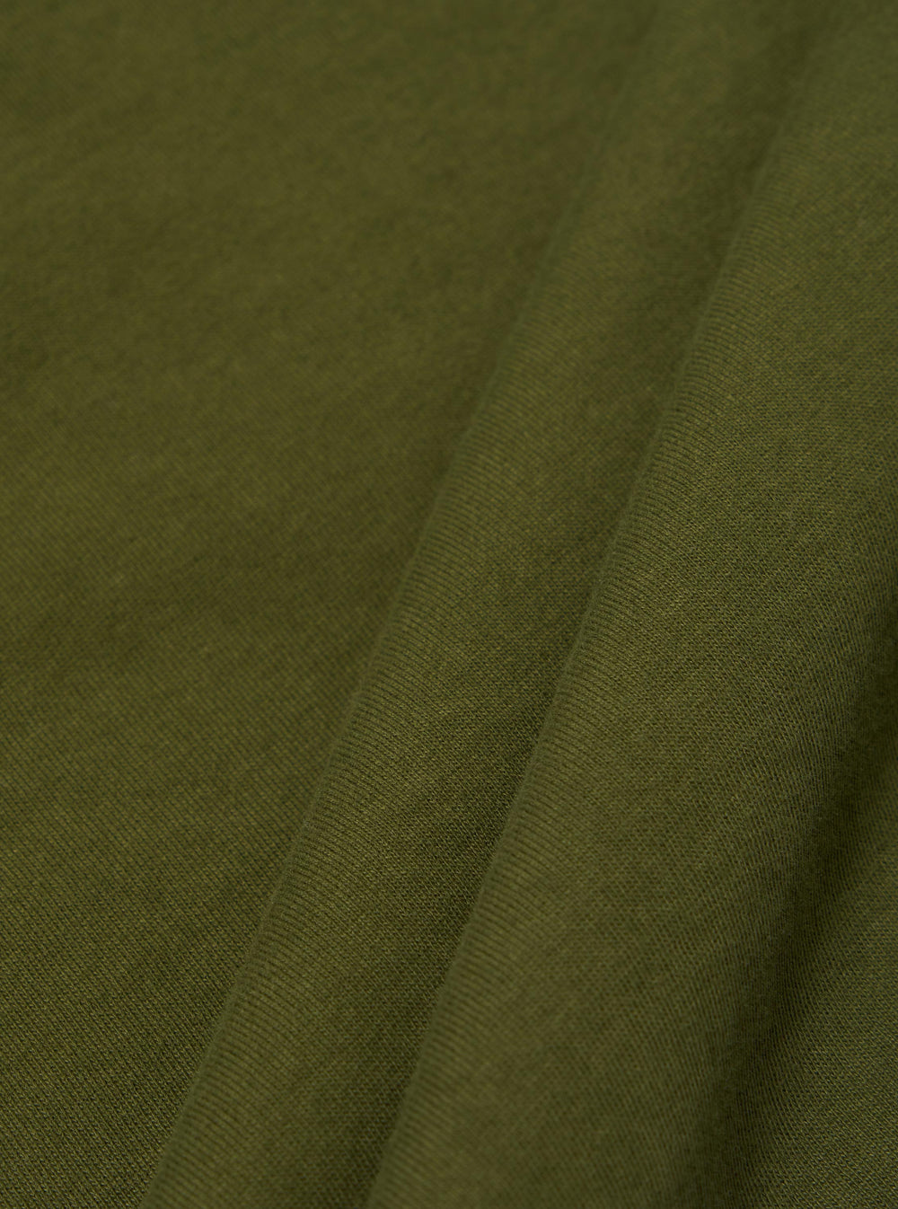 A close-up swatch image of the Olive Rugby Jersey Oversized Vacation Polo fabric. The image focuses on the olive green organic cotton material, highlighting its soft, jersey knit texture and consistent color.