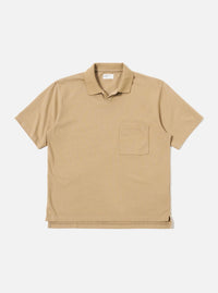 The Sand Rugby Jersey Oversized Vacation Polo is shown as a flat lay against a white background. The polo features an oversized fit, a one-piece collar, a short placket with no fastening, and a single patch pocket on the left chest. The fabric is a heavy-weight rugby jersey in a neutral sand color.