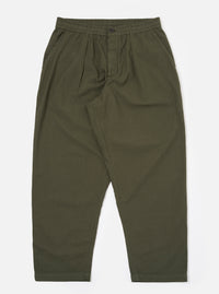 The Olive Merida Seersucker Pleated Track Pant is shown as a flat lay against a plain white background. The image highlights the elasticated waistband with an external drawstring, the single pleat at the front, and the tapered leg design. The olive green cotton fabric features a distinct puckered seersucker texture with a subtle checkered pattern.